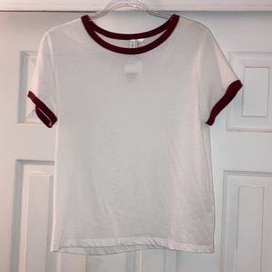 White tee shirt with red on sleeves and neck